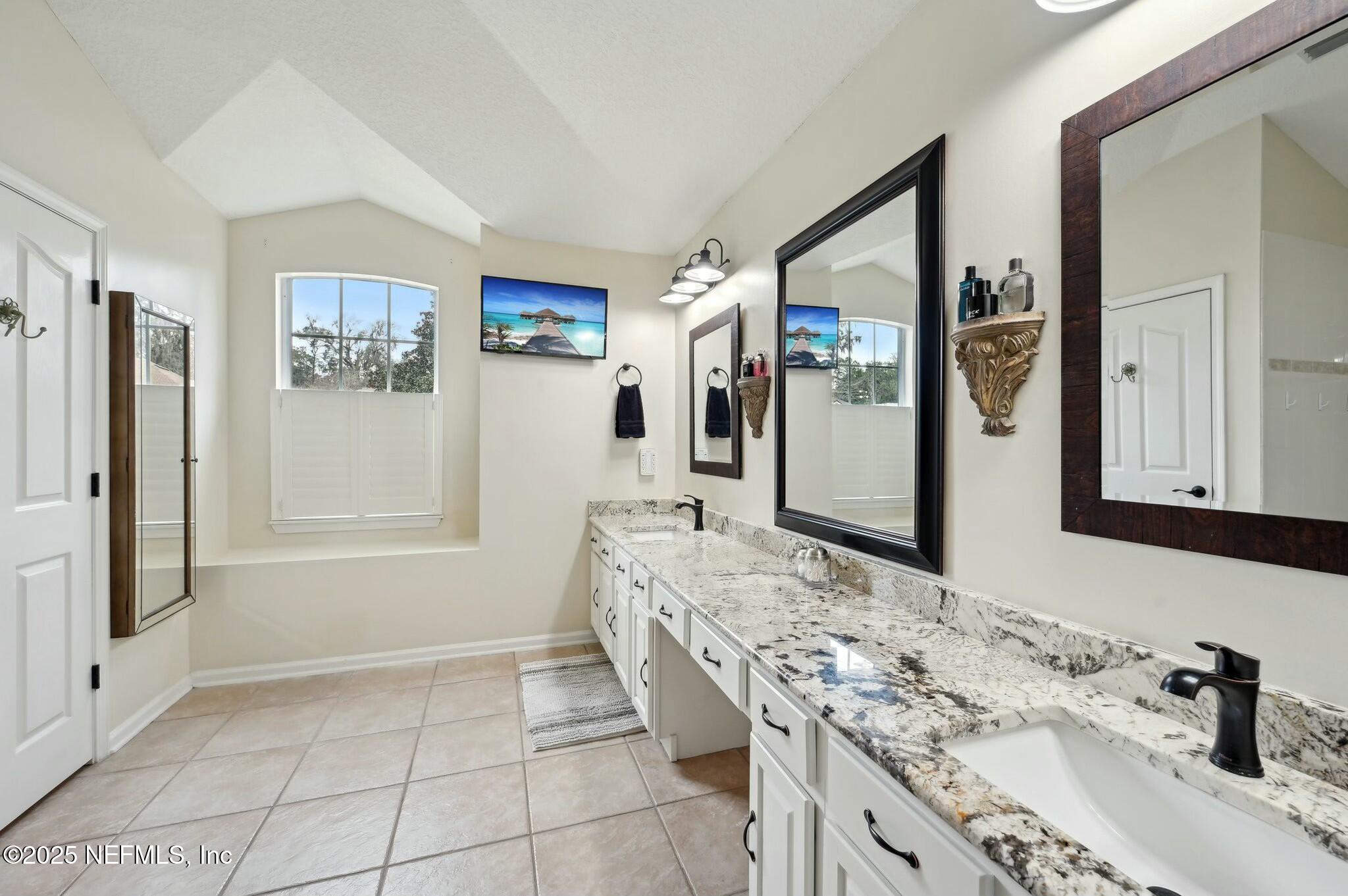 1732 Margarets Walk Road Fleming Island, FL 32003 - Photo 26 of 55 a bathroom with a granite countertop sink mirror and shower