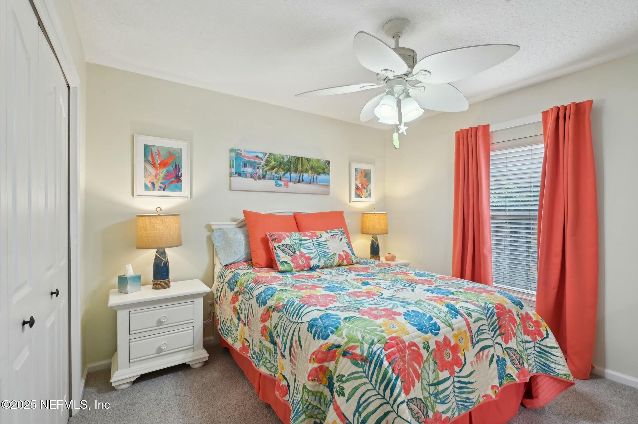 1732 Margarets Walk Road Fleming Island, FL 32003 - Photo 28 of 55 a bedroom with a bed and a chandelier