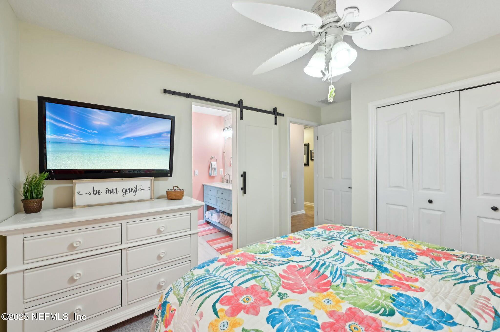 1732 Margarets Walk Road Fleming Island, FL 32003 - Photo 30 of 55 a bedroom with a bed and a flat screen tv in it