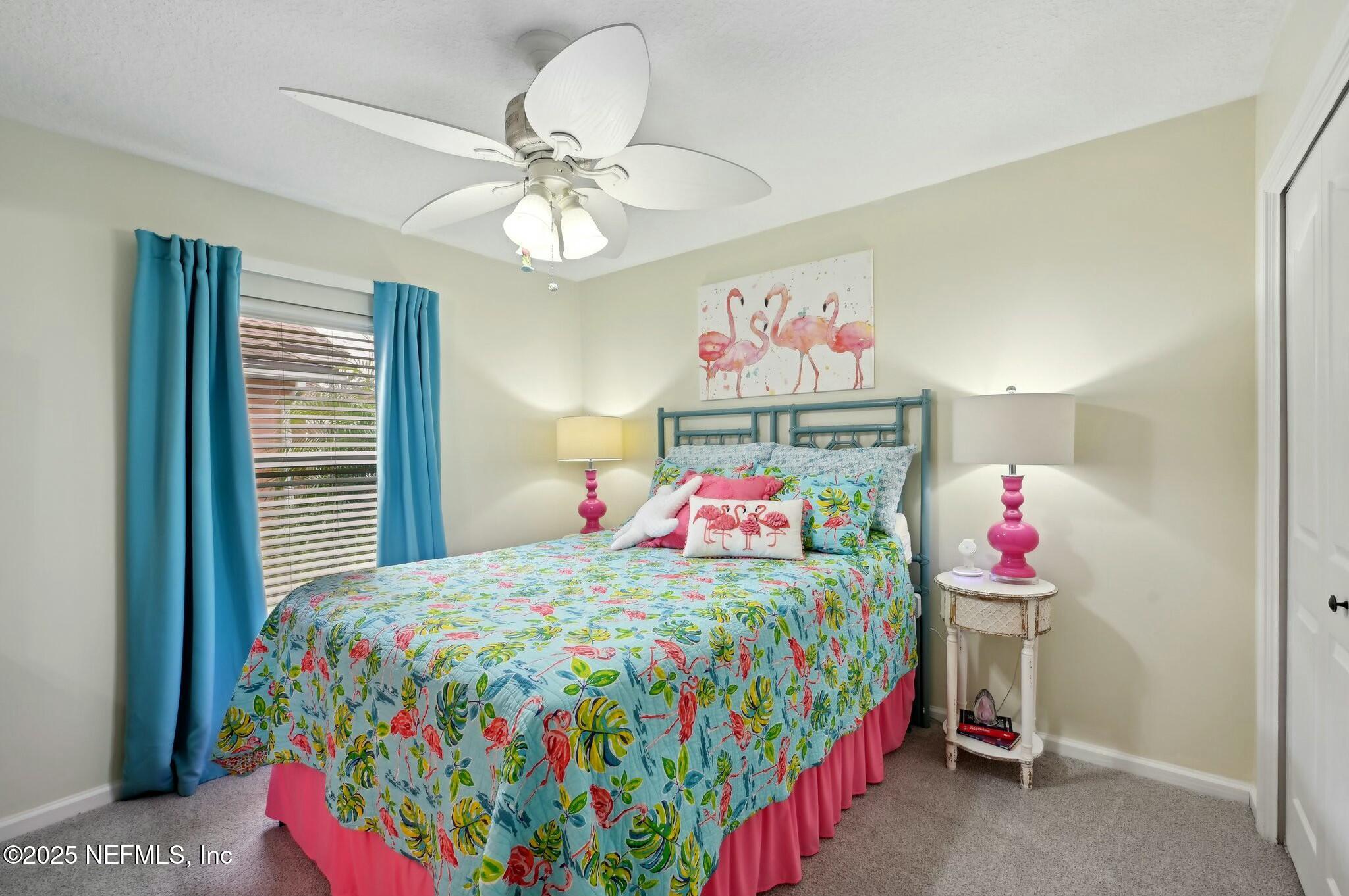 1732 Margarets Walk Road Fleming Island, FL 32003 - Photo 34 of 55 a bedroom with a bed a chandelier and closet