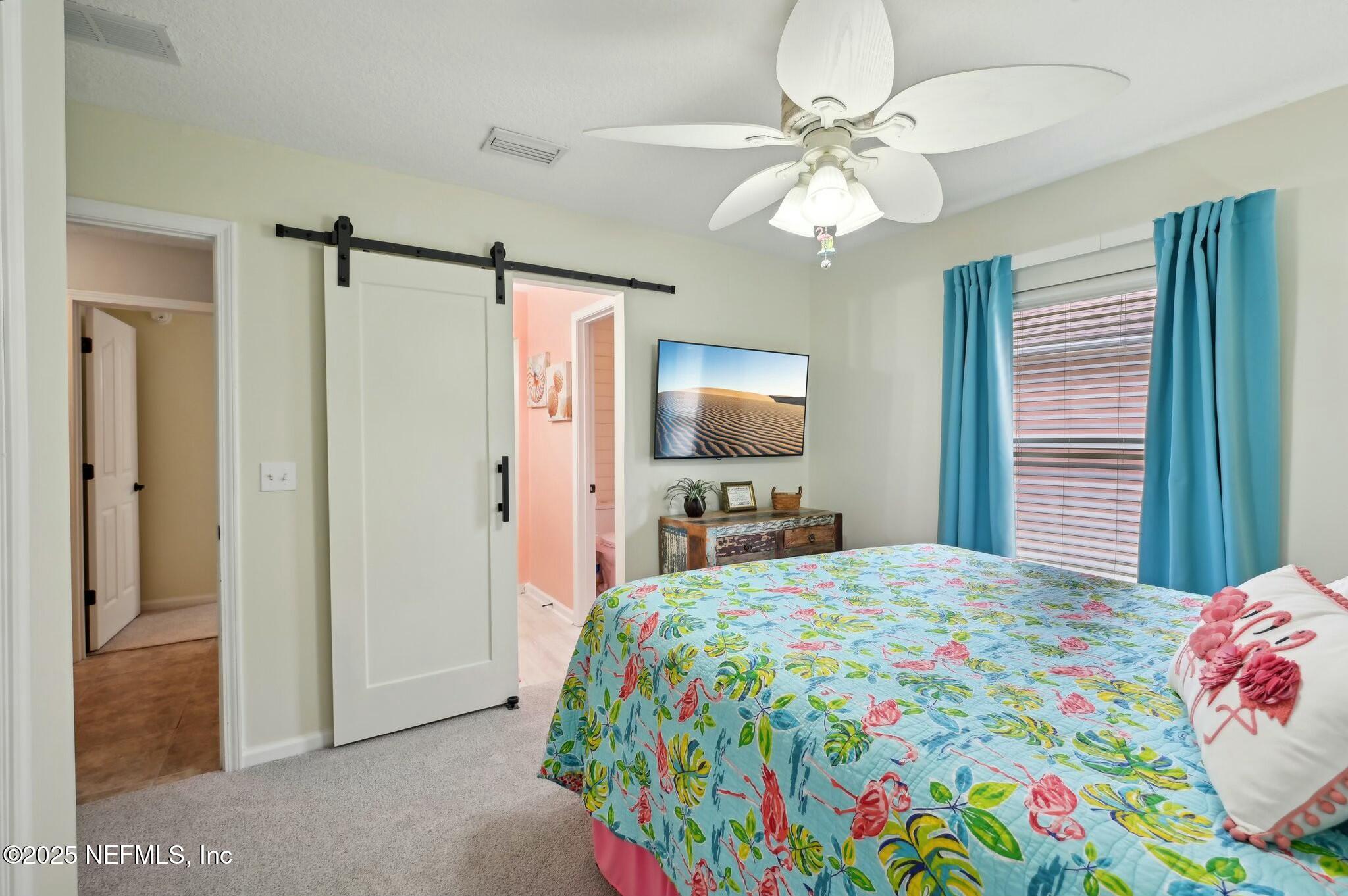 1732 Margarets Walk Road Fleming Island, FL 32003 - Photo 36 of 55 a bedroom with a bed and a flat tv screen on dresser