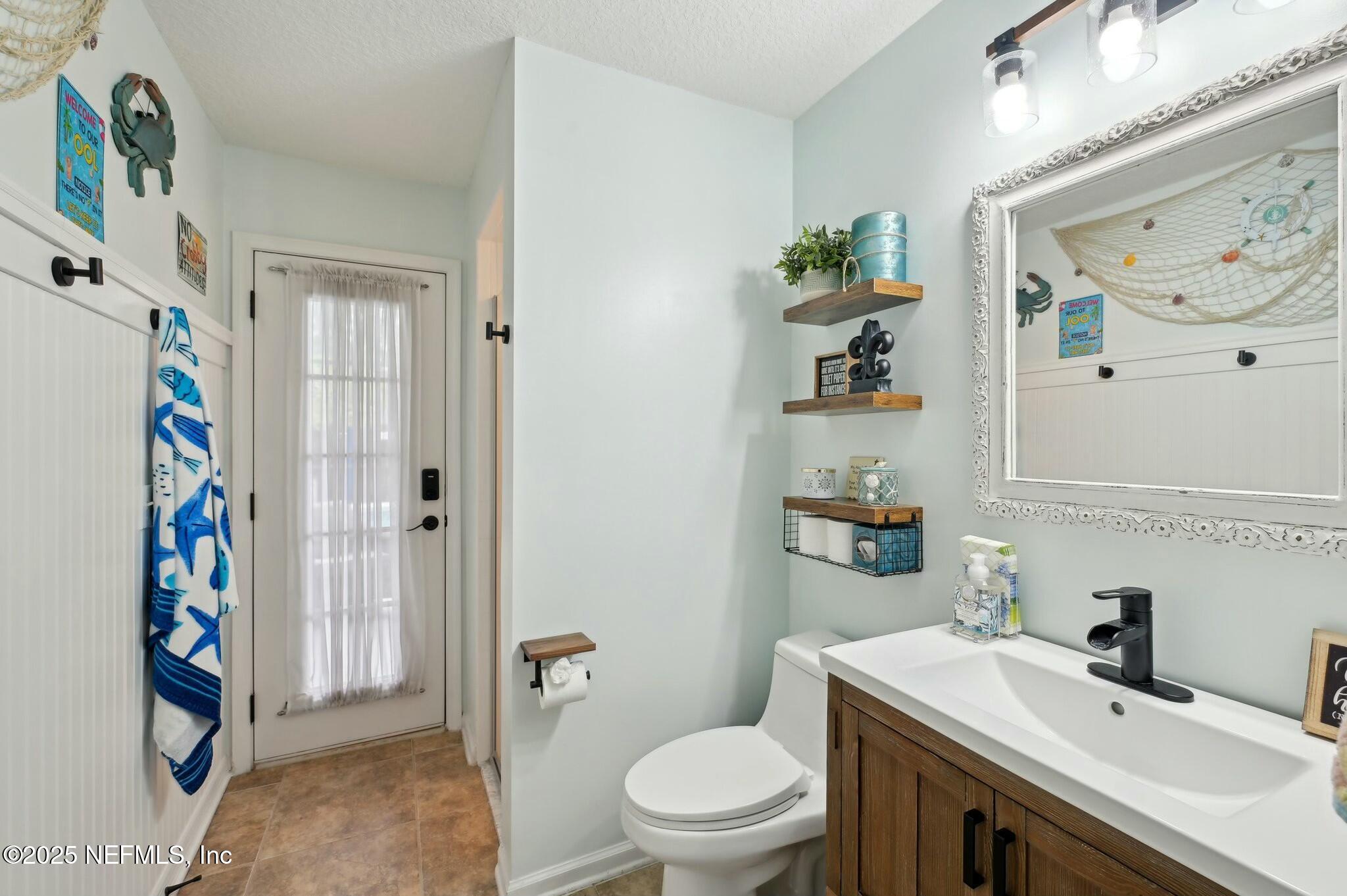 1732 Margarets Walk Road Fleming Island, FL 32003 - Photo 41 of 55 a bathroom with a sink a toilet and a shower curtain