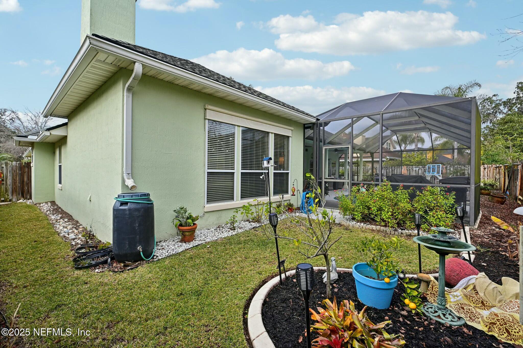1732 Margarets Walk Road Fleming Island, FL 32003 - Photo 49 of 55 a view of a house with backyard sitting area and garden