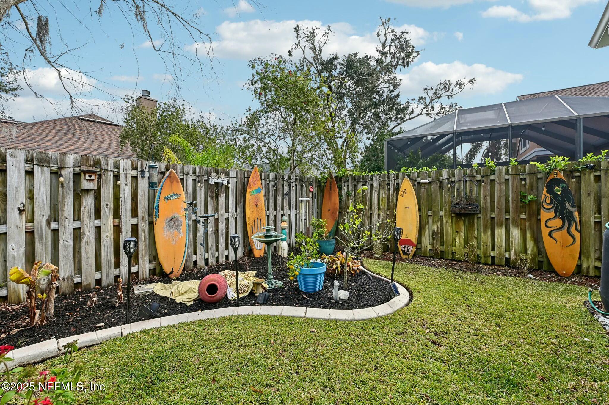 1732 Margarets Walk Road Fleming Island, FL 32003 - Photo 50 of 55 a view of a backyard with table and chairs and potted plants