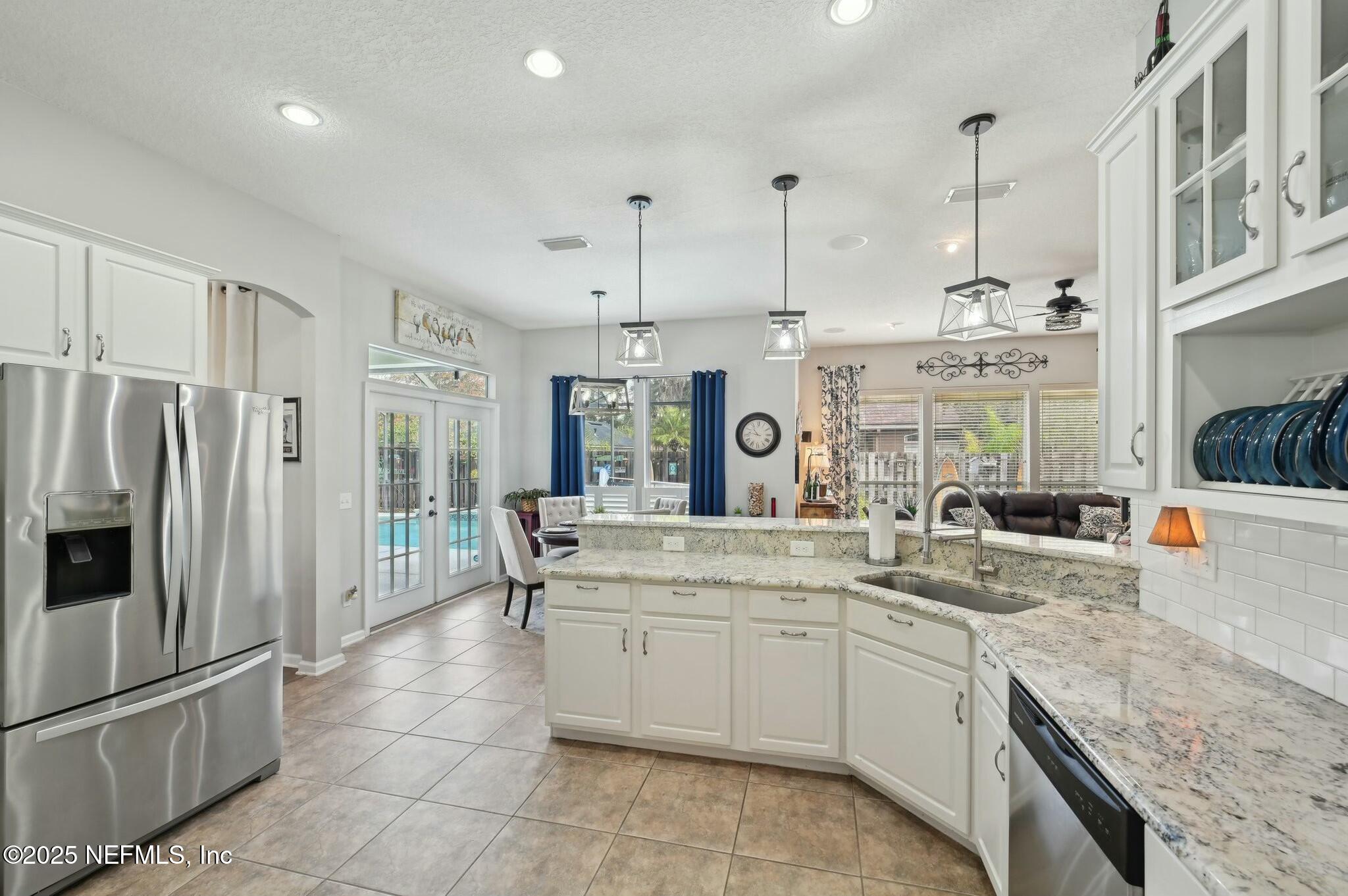 1732 Margarets Walk Road Fleming Island, FL 32003 - Photo 10 of 55 a kitchen with stainless steel appliances granite countertop a sink stove and refrigerator
