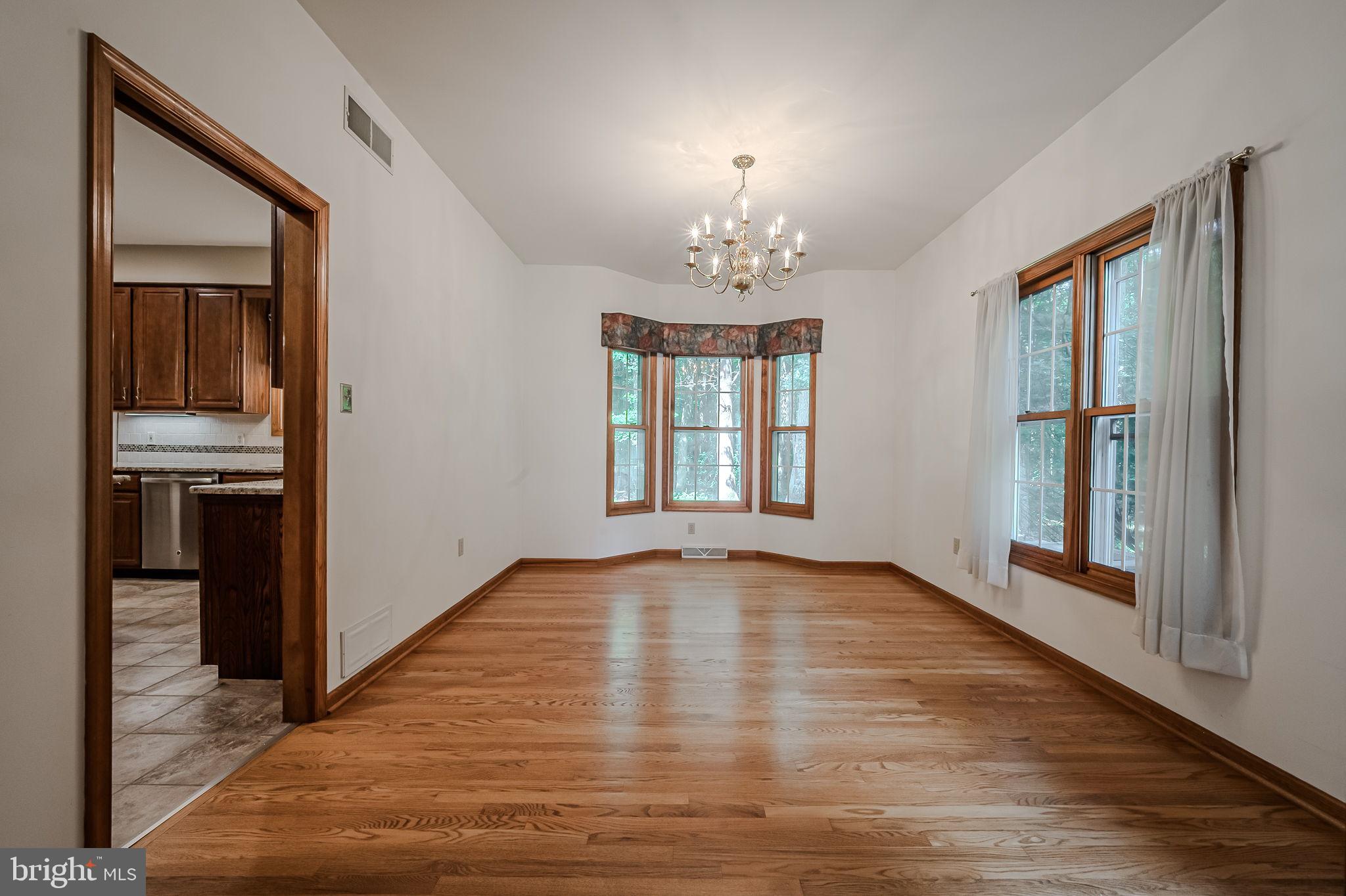 108 Michaels Lane Newark, DE 19713 - Photo 13 of 53 wooden floor in an empty room with a window