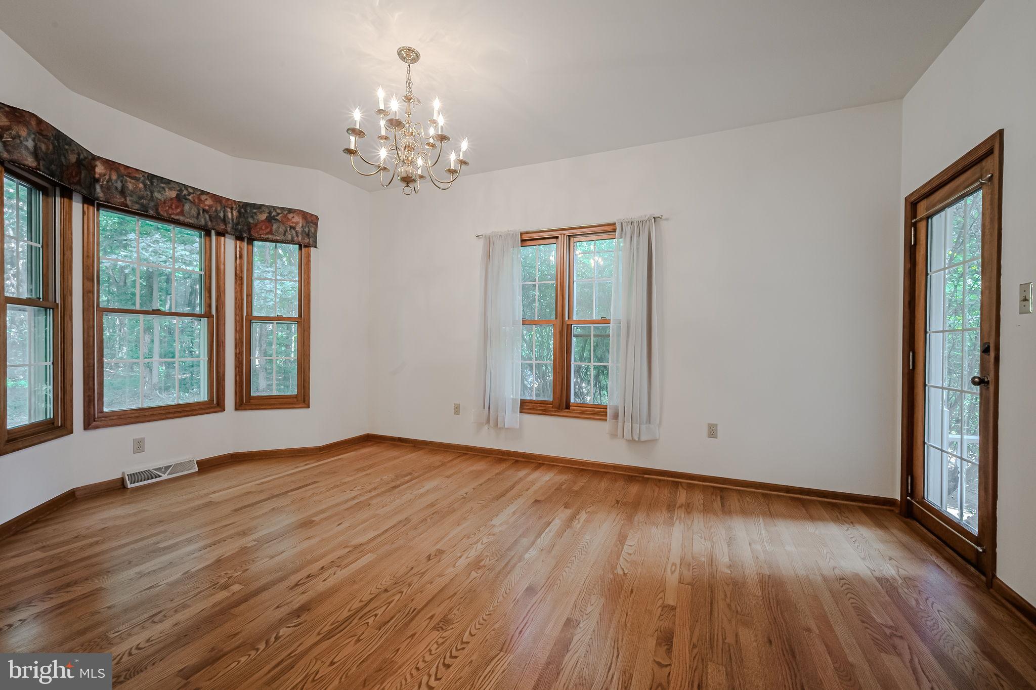 108 Michaels Lane Newark, DE 19713 - Photo 14 of 53 a view of an empty room with wooden floor and a window