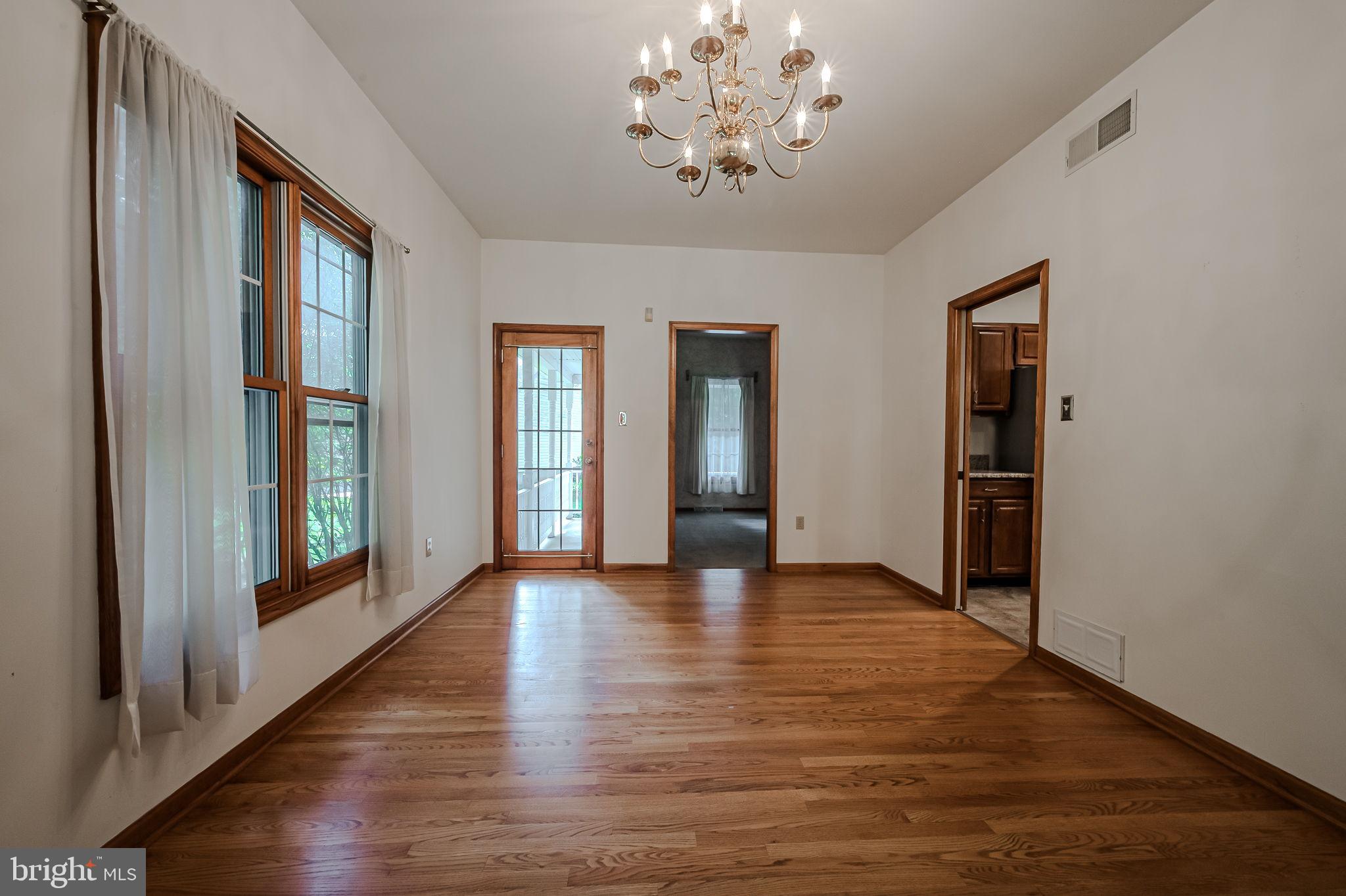 108 Michaels Lane Newark, DE 19713 - Photo 15 of 53 an empty room with wooden floor and windows