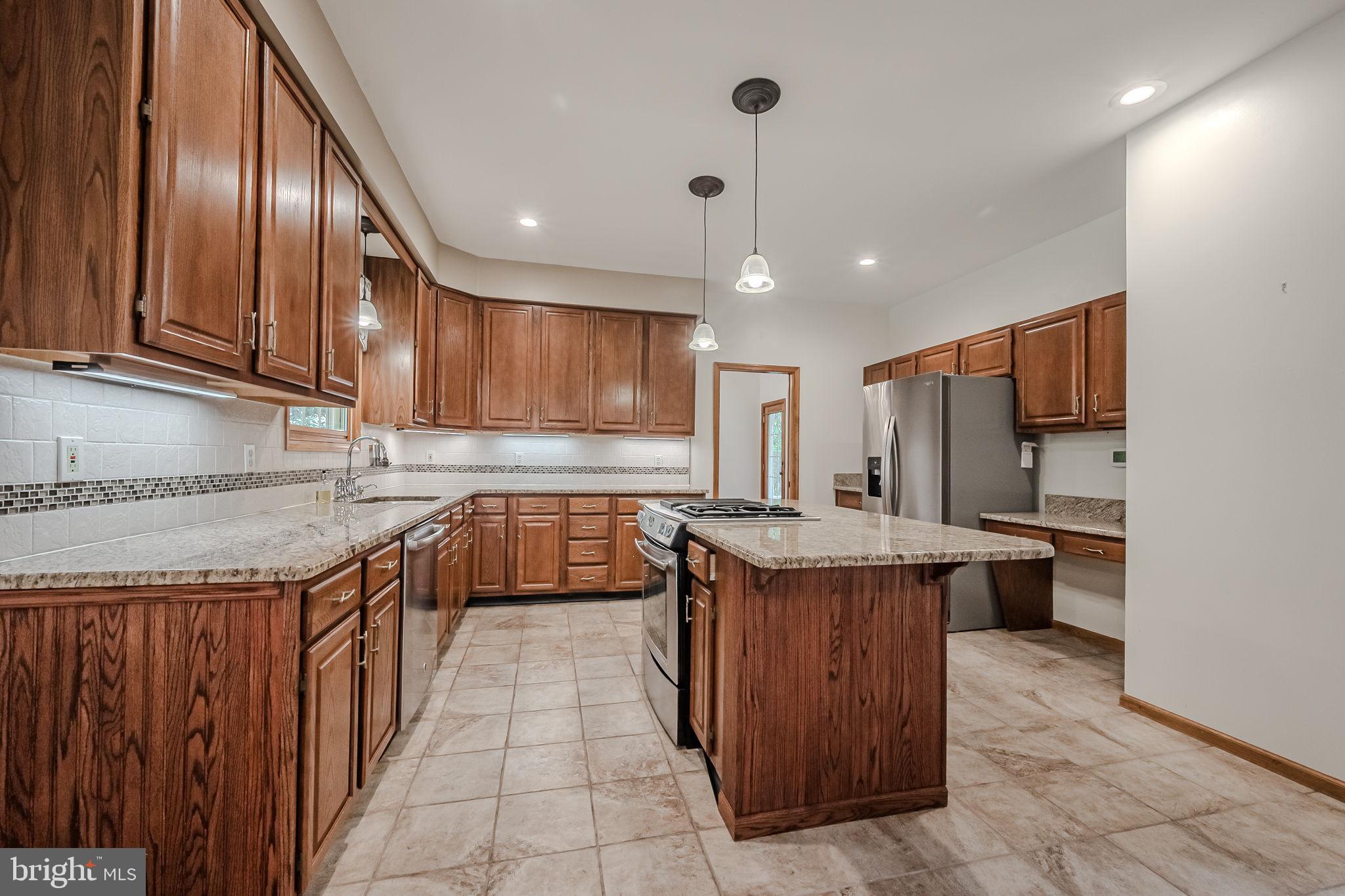 108 Michaels Lane Newark, DE 19713 - Photo 17 of 53 a kitchen with stainless steel appliances granite countertop a stove a sink dishwasher a refrigerator and a oven