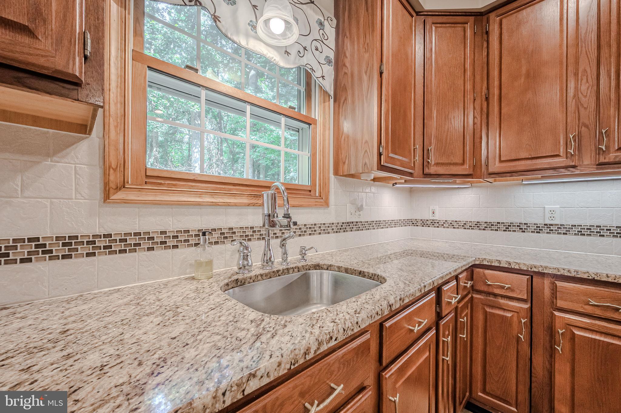 108 Michaels Lane Newark, DE 19713 - Photo 19 of 53 a kitchen with granite countertop a sink and a window