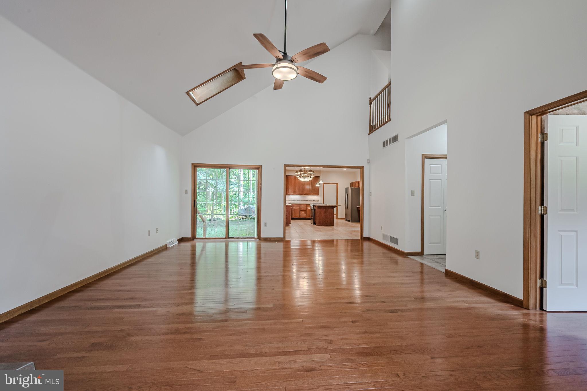 108 Michaels Lane Newark, DE 19713 - Photo 26 of 53 a view of an empty room with window and wooden floor