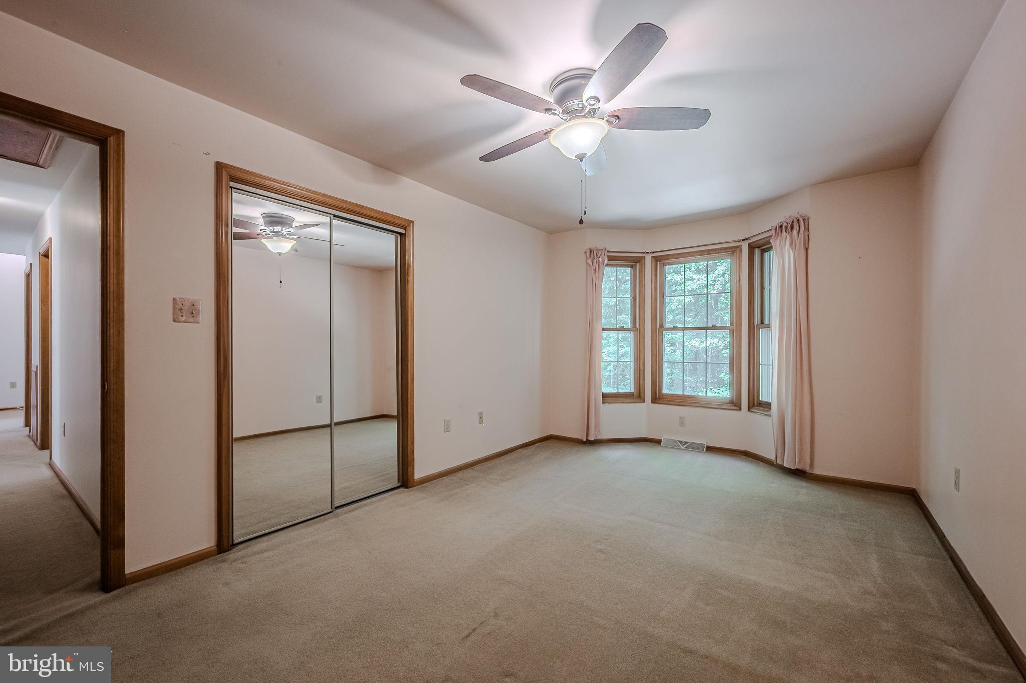 108 Michaels Lane Newark, DE 19713 - Photo 36 of 53 an empty room with chandelier fan and windows