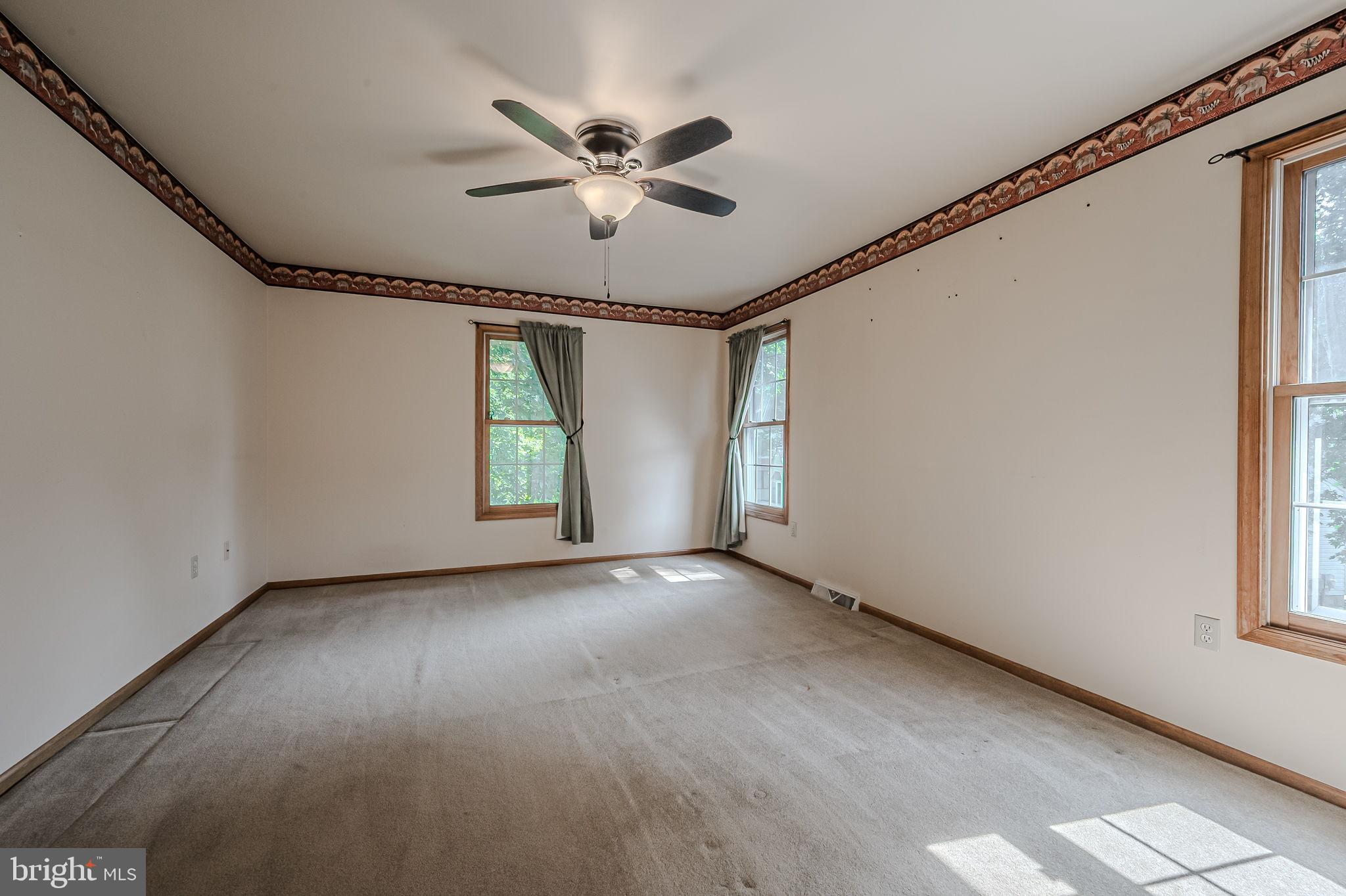 108 Michaels Lane Newark, DE 19713 - Photo 39 of 53 an empty room with windows and fan