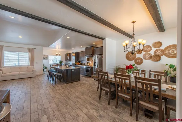 a bedroom with furniture and a flat screen tv