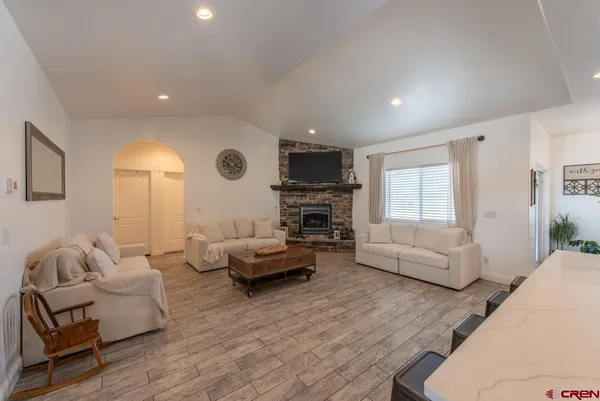 a view of a room with a lounge chair a ceiling fan
