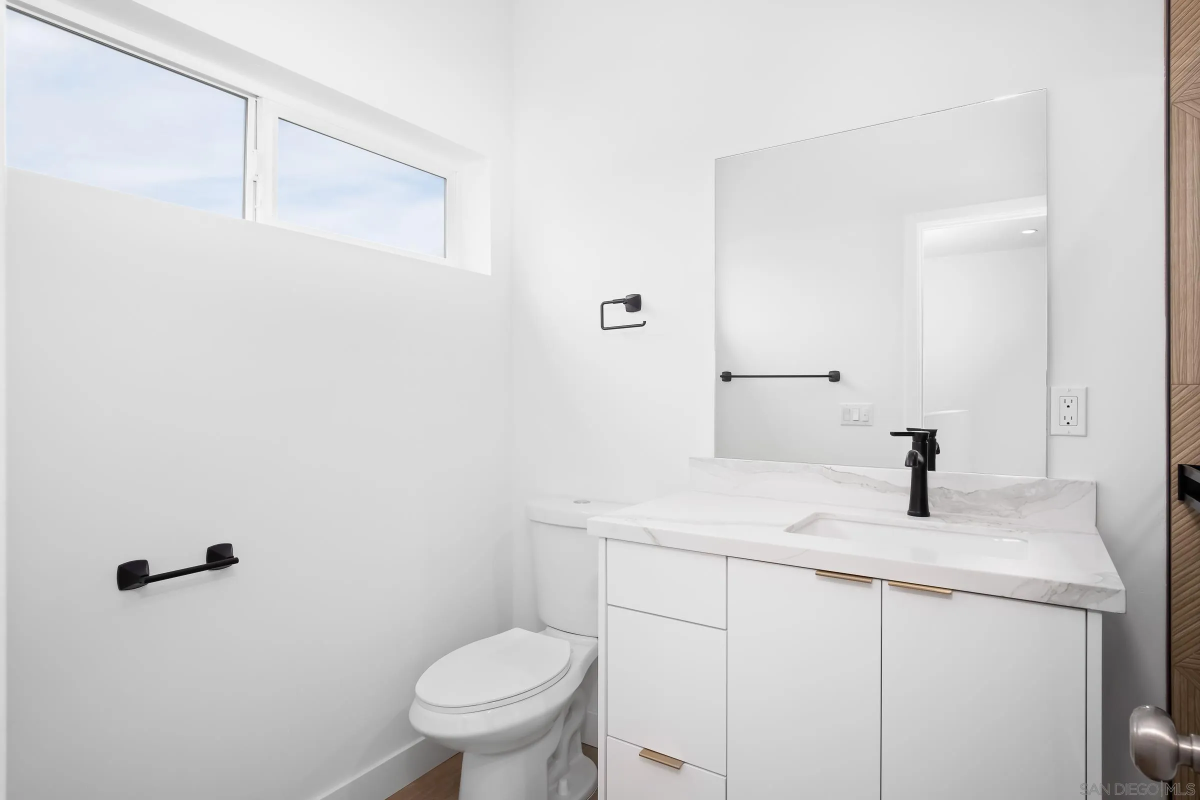 5230-32 Rincon Street San Diego, CA 92115 - Photo 18 of 29 a bathroom with a granite countertop sink toilet and a mirror