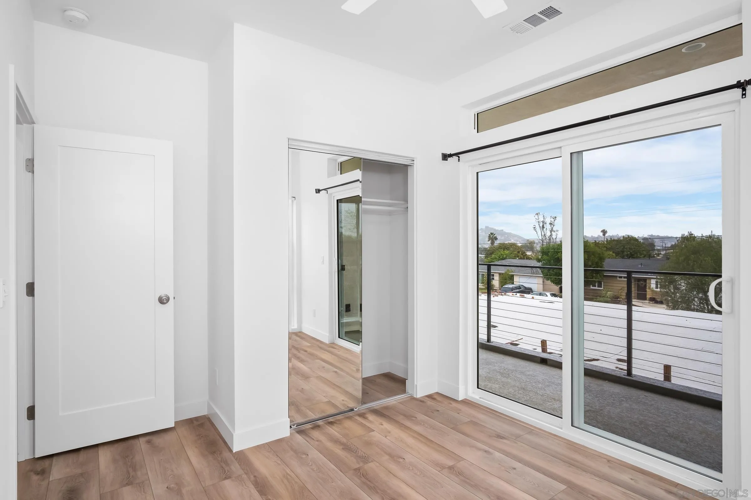 5230-32 Rincon Street San Diego, CA 92115 - Photo 27 of 29 an empty room with wooden floor and windows