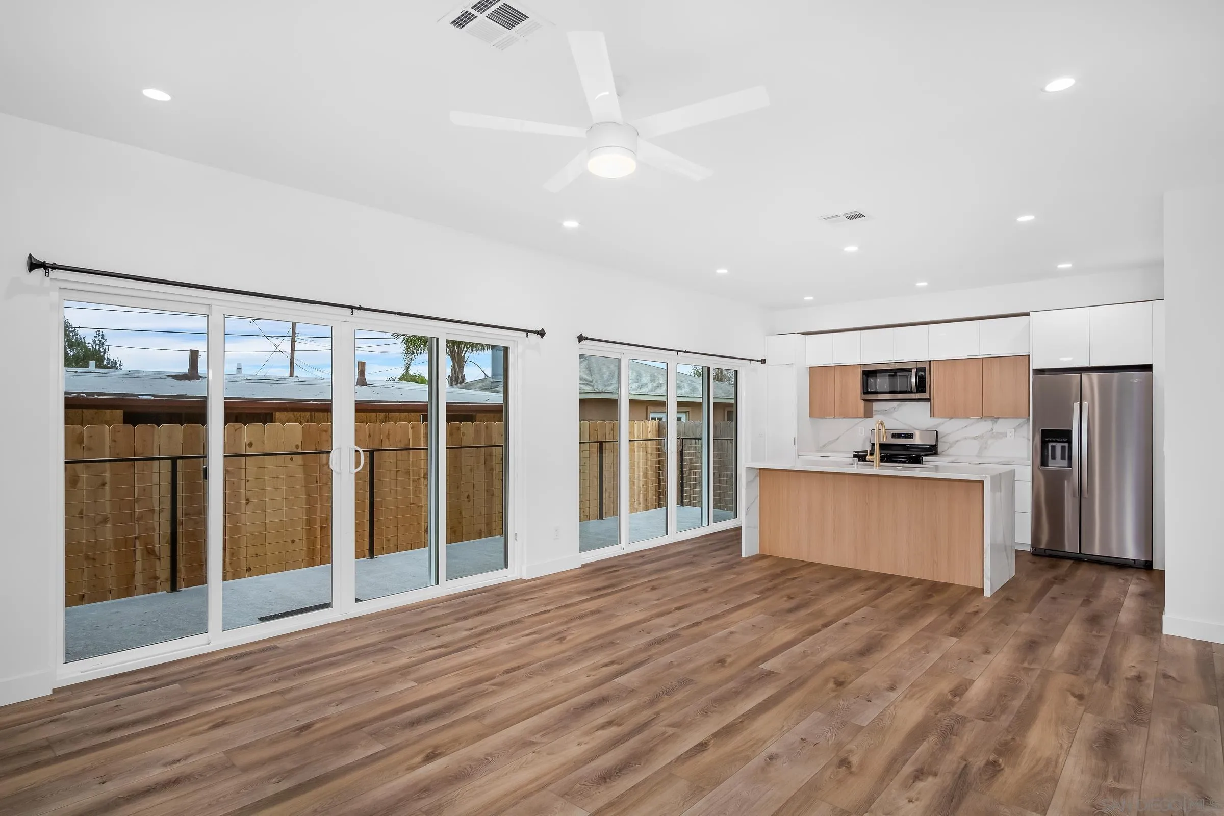 5230-32 Rincon Street San Diego, CA 92115 - Photo 5 of 29 a large kitchen with stainless steel appliances granite countertop a large counter top and oven
