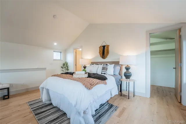 a bed room with a bed and a lamp