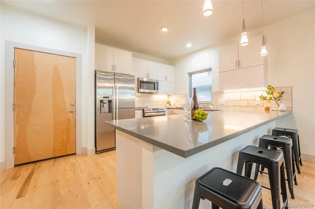 a view of a porch with furniture and wooden floor