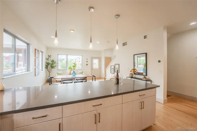 a living room with a bed furniture and wooden floor