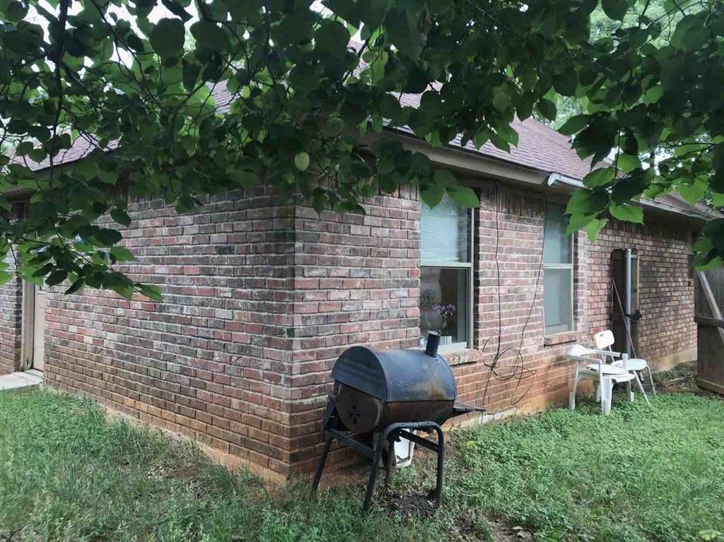 4904 Saddleback Road Arlington, TX 76017 - Photo 8 of 8 a view of a chairs and table in backyard of the house