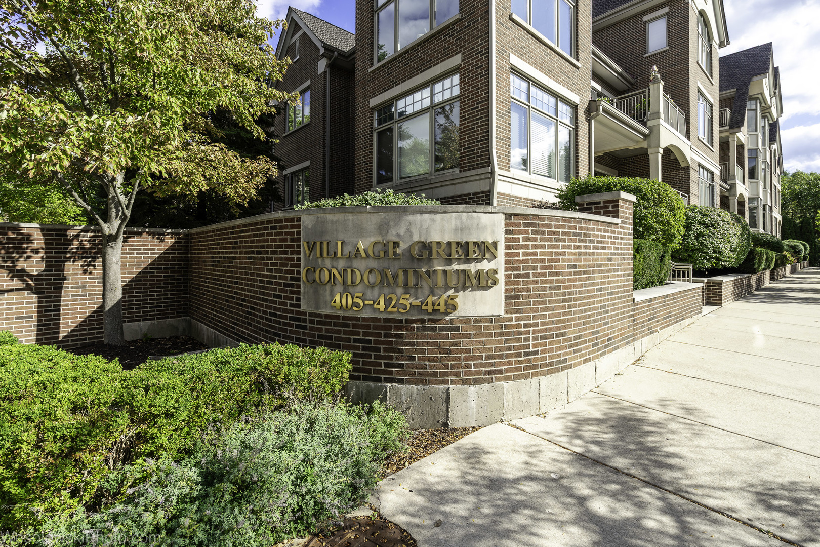 a view of a brick house with many windows