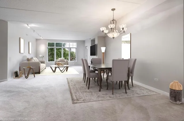 a view of a dining room with furniture and chandelier
