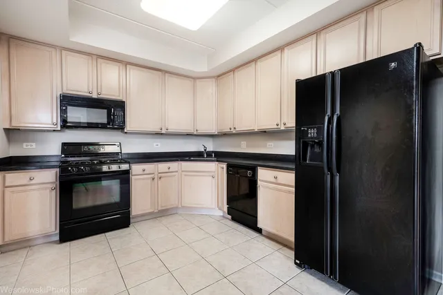 a kitchen with a sink stove and refrigerator