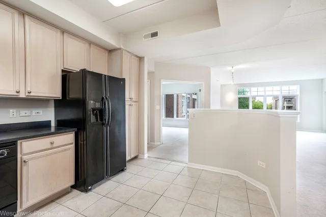 a kitchen with a refrigerator a stove and cabinets