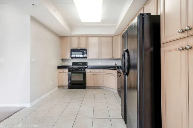 a kitchen with a refrigerator sink and microwave