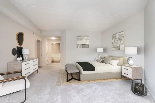 a bedroom with a bed and a large mirror