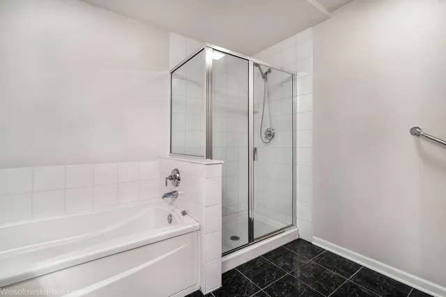 a bathroom with a bathtub and a shower