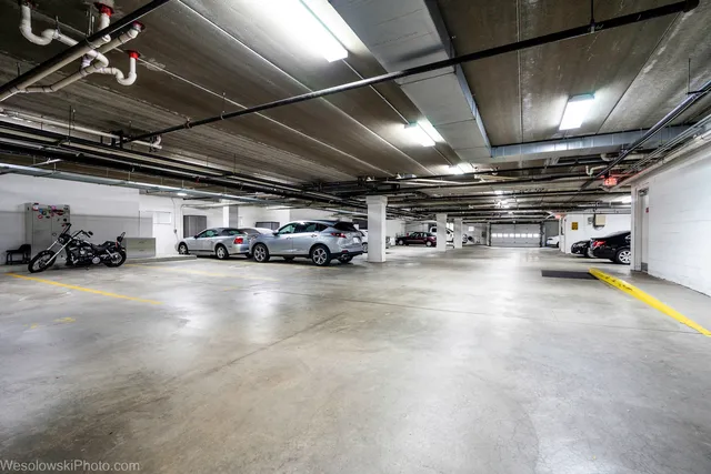 a view of parking garage with cars
