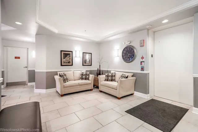 a living room with furniture and wall paintings