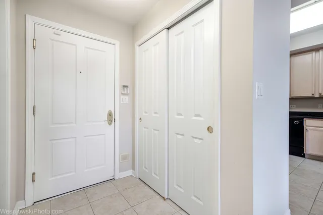 a view of a hallway with kitchen area