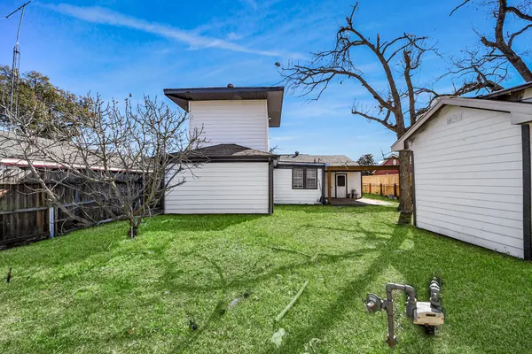 a big house with a big yard and large trees