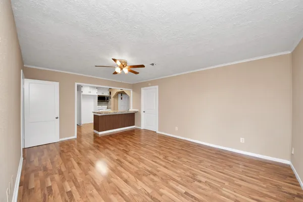 a kitchen with granite countertop a sink window and cabinets