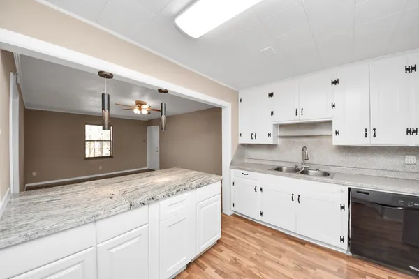 a kitchen with stainless steel appliances a stove a sink and a refrigerator