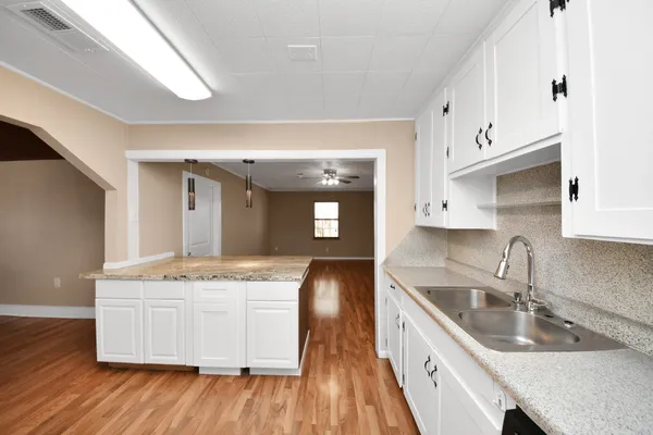 a kitchen with kitchen island a sink stainless steel appliances and cabinets