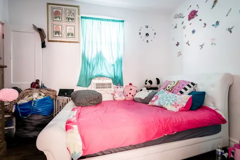 a bedroom with bed and a chandelier