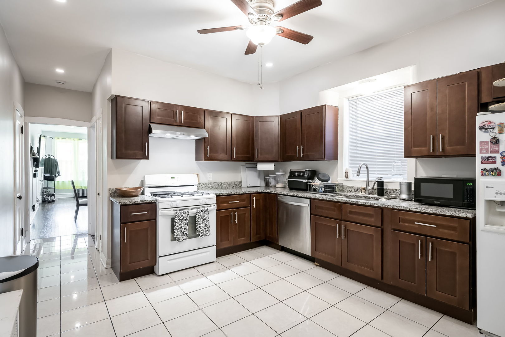 4554 South Washtenaw Avenue Chicago, IL 60632 - Photo 16 of 40 a kitchen with stainless steel appliances granite countertop a stove cabinets a sink and a refrigerator