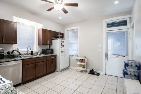 a kitchen with a sink cabinets and stainless steel appliances