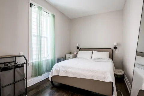 a bedroom with a bed and a window