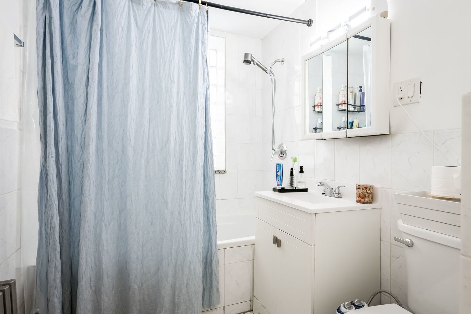 4554 South Washtenaw Avenue Chicago, IL 60632 - Photo 20 of 40 a bathroom with a sink a toilet and a mirror