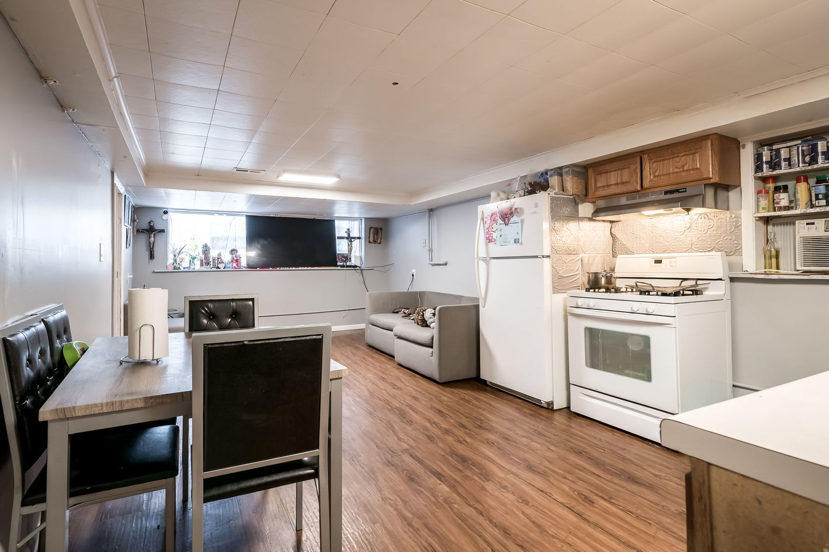 4554 South Washtenaw Avenue Chicago, IL 60632 - Photo 31 of 40 a kitchen with stainless steel appliances a stove a sink dishwasher a refrigerator white cabinets and wooden floor