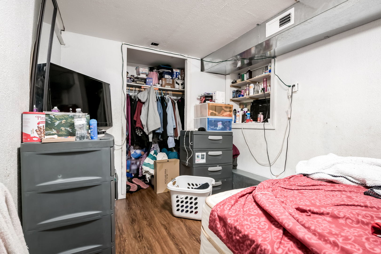 4554 South Washtenaw Avenue Chicago, IL 60632 - Photo 34 of 40 a bedroom with a bed a flat screen tv and a window