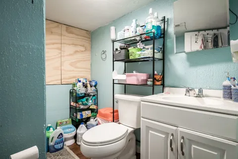 a bathroom with a sink mirror vanity and toilet