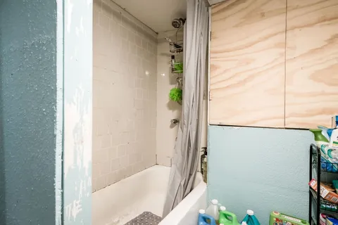 a bathroom with a bathtub and shower