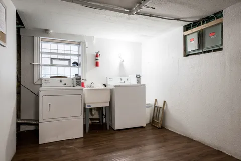 a utility room with cabinets washer and dryer